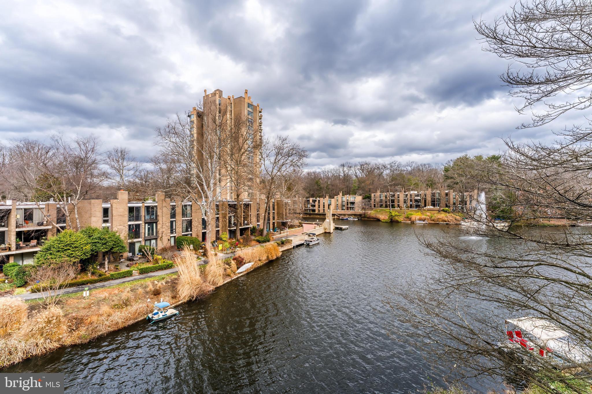 11434 Waterview Cluster Reston, VA 20190 - Photo 53 of 63 a view of a lake with boats and buildings in the background