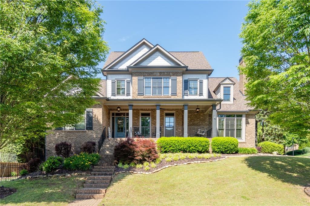 a front view of a house with yard and green space