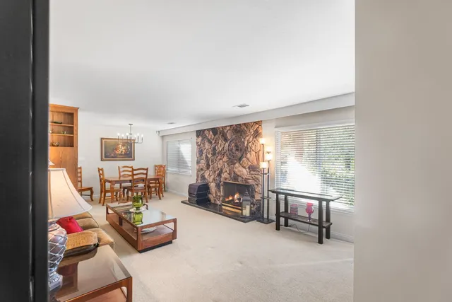 a view of a house with a big yard and potted plants