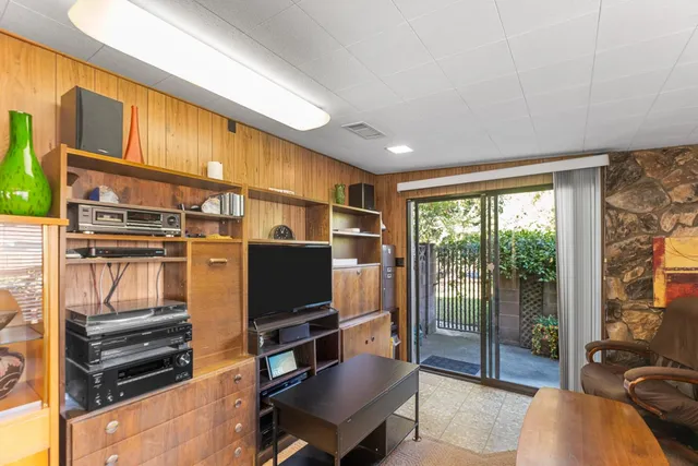 a view of a patio with table and chairs under an umbrella