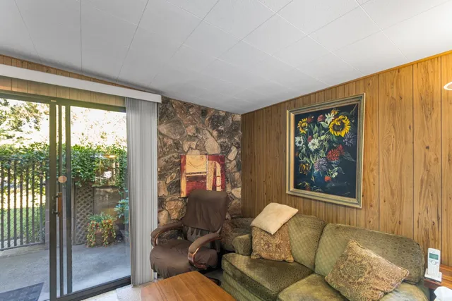 a view of a house with backyard and sitting area