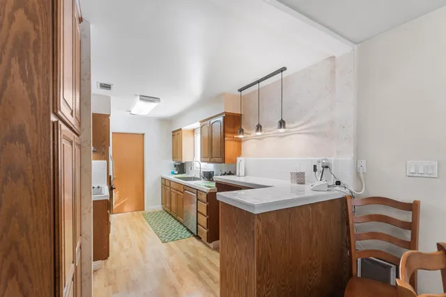 a bedroom with a bed and a lamp next to a window