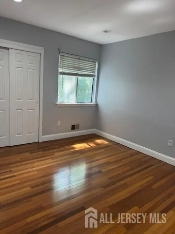 a view of a room with wooden floor and windows