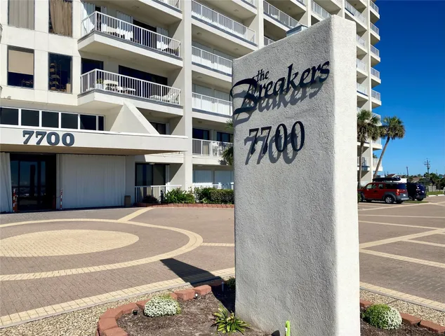 a front view of a building with a street sign