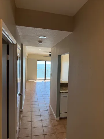 a hallway with a sink and a mirror