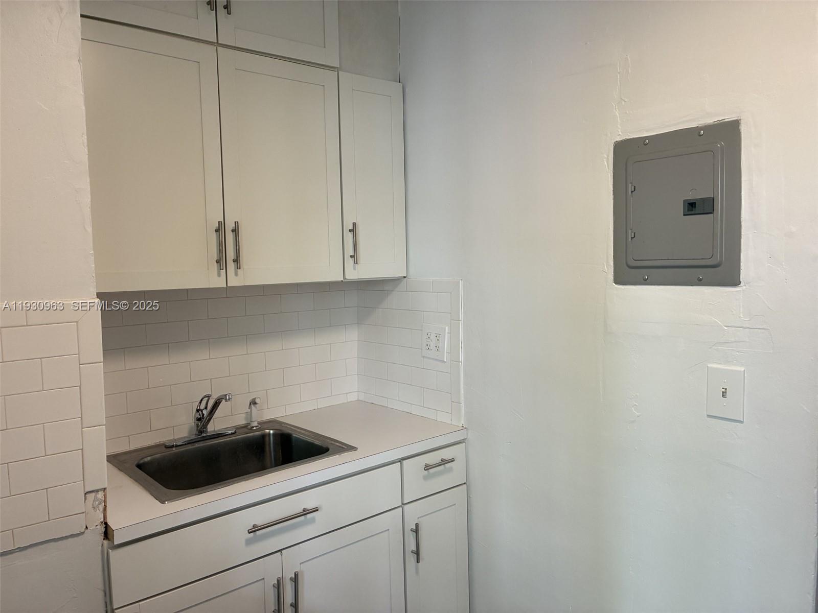 2469 Flamingo Place, Unit 2 Miami Beach, FL 33140 - Photo 11 of 22 a view of a sink and cabinets