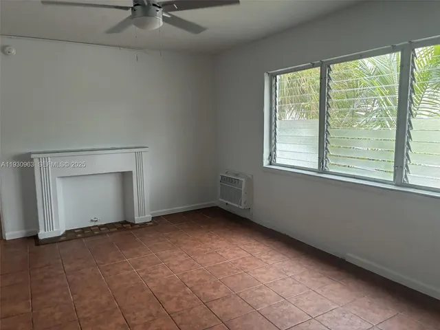 a view of an empty room and a window