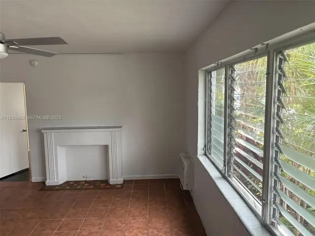 a view of a room with wooden floor and a cabinet