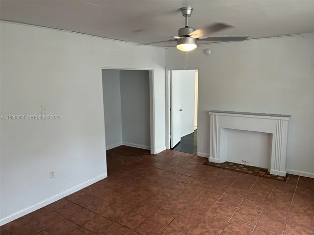 a kitchen with white cabinets and appliances