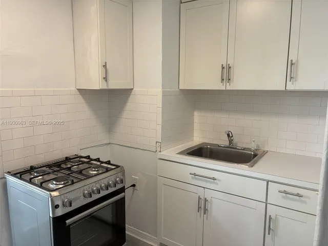 a view of a sink and cabinets