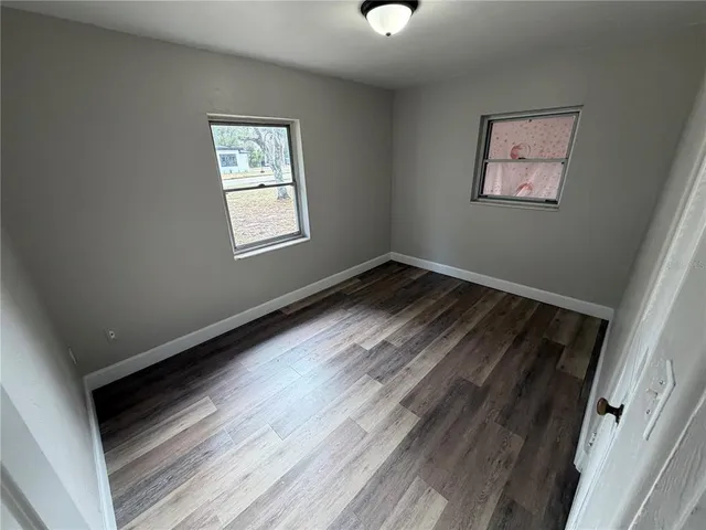 a view of room with window and hardwood floor