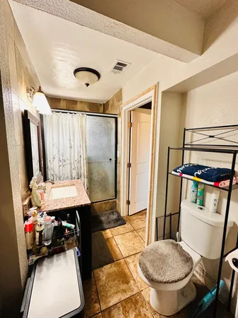 a bedroom with double bed and a couch