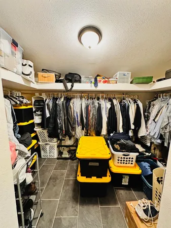 a view of a room with lots of furniture and clutter