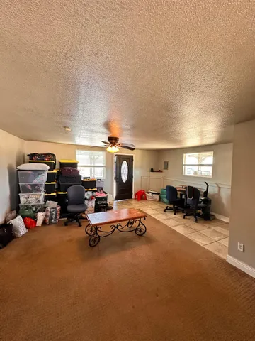 a view of a room with lots of furniture and clutter