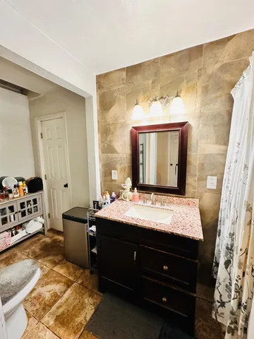 a room with a bed and a mirror on a dresser