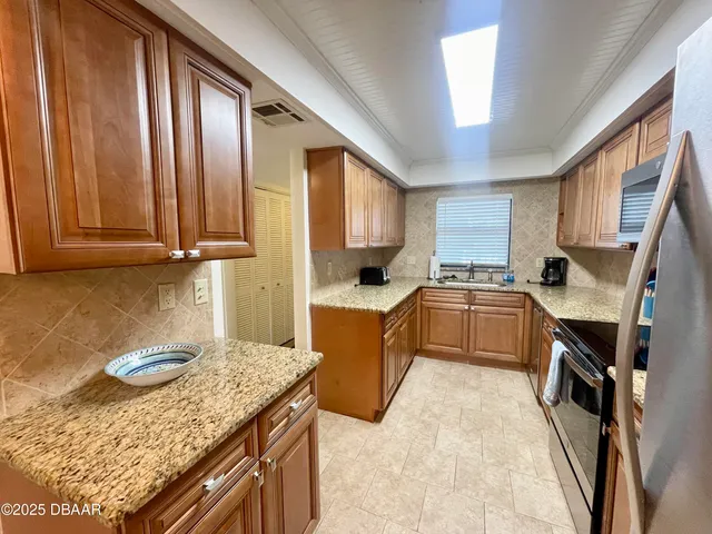 a kitchen with a stove a sink and a refrigerator