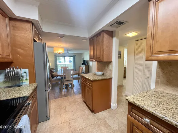 a kitchen with granite countertop a sink stove and cabinets