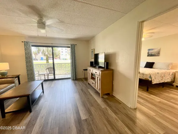 a view of a bedroom with furniture flat screen tv and windows