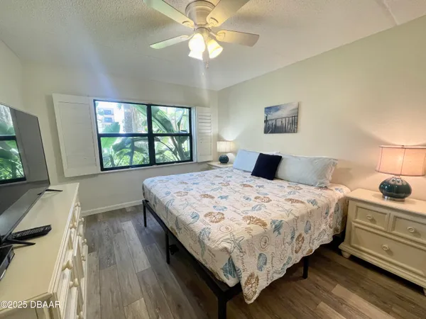 a bedroom with a bed and a large window