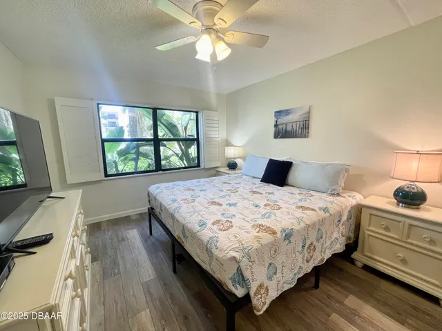 a bedroom with a bed and a large window