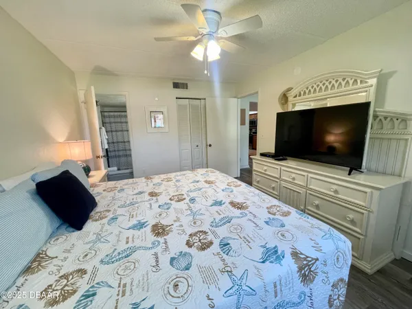 a bedroom with a bed and a flat screen tv