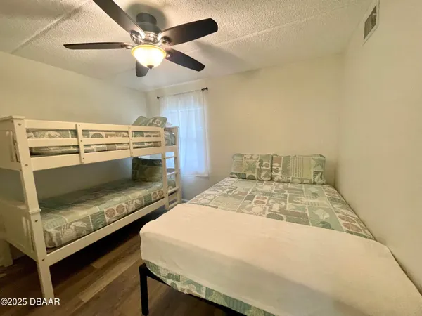 a bedroom with a bed and a ceiling fan