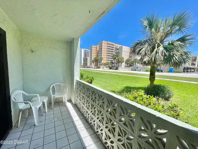 a view of a balcony with lake view and a potted plant