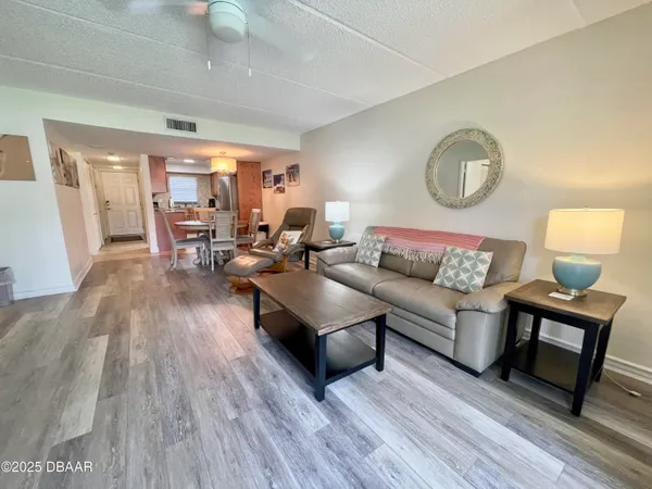 a living room with furniture and wooden floor