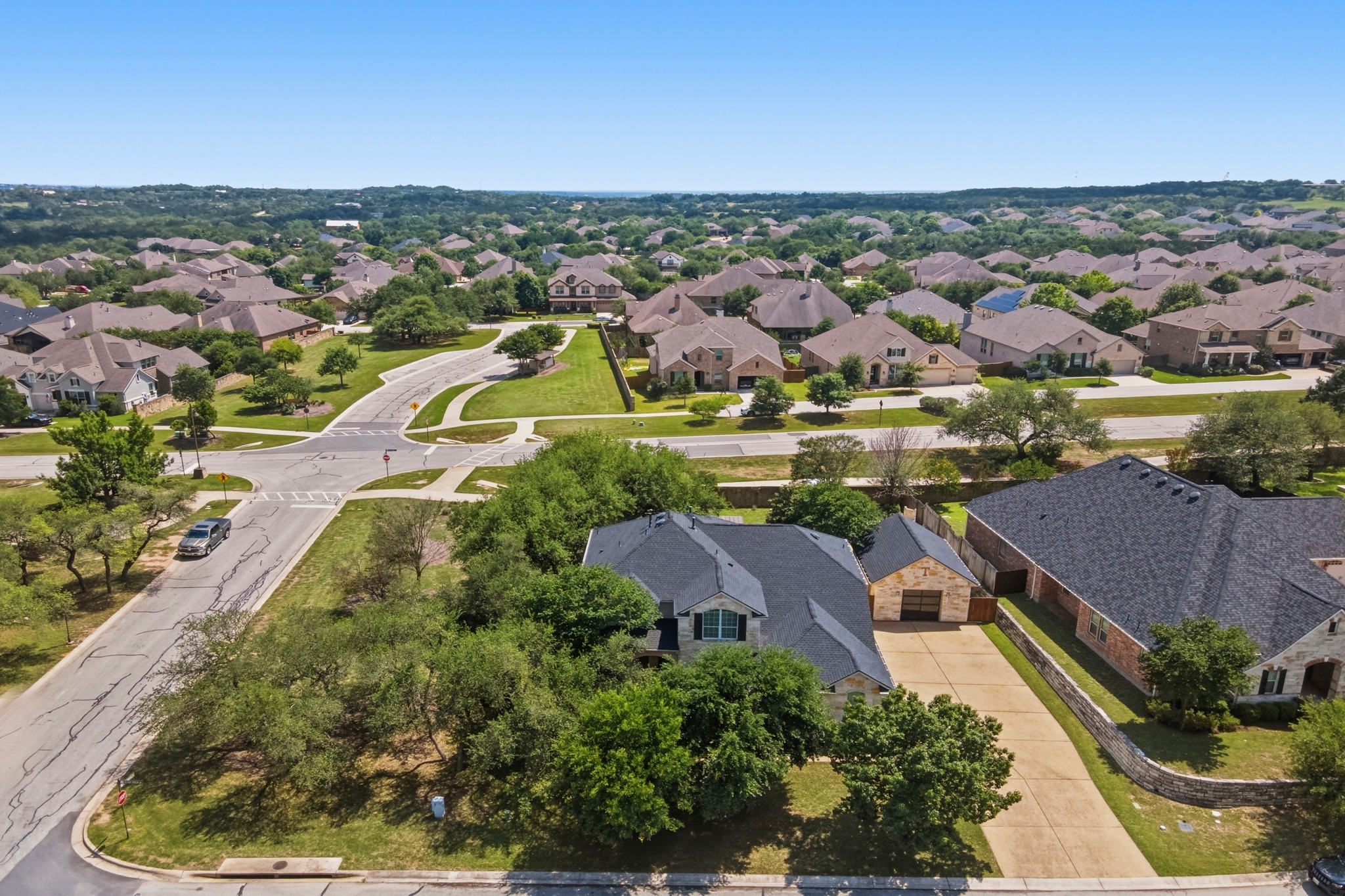 1023 Grassy Field Road Austin, TX 78737 - Photo 38 of 40 Aerial perspective showing 3300+ sq ft residence and 480 sq ft fully finished detached garage surrounded by mature trees.
