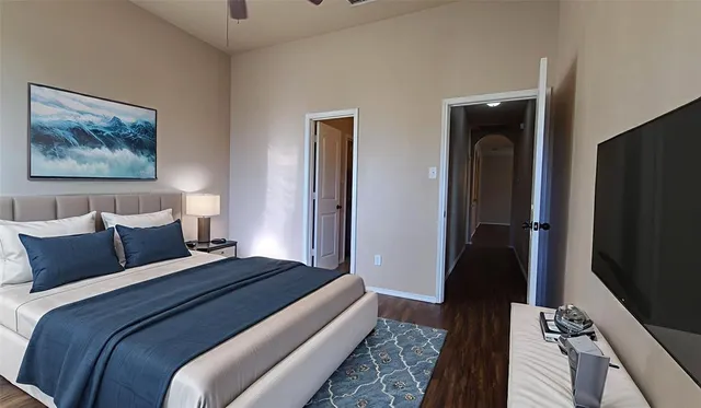 a bedroom with bed and wooden floor