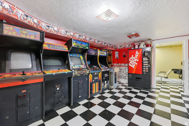 2342 Charros Road Sandy, UT 84092 - Photo 51 of 94 Recreation room with black and white checkered flooring, red accent walls, and recessed lighting