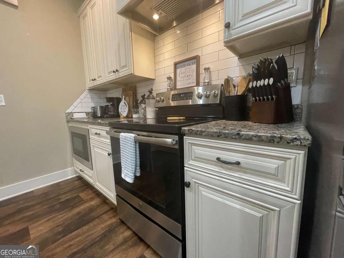 457 Old Good Hope Road Good Hope, GA 30641 - Photo 7 of 59 a kitchen with stainless steel appliances granite countertop a stove and a white cabinets