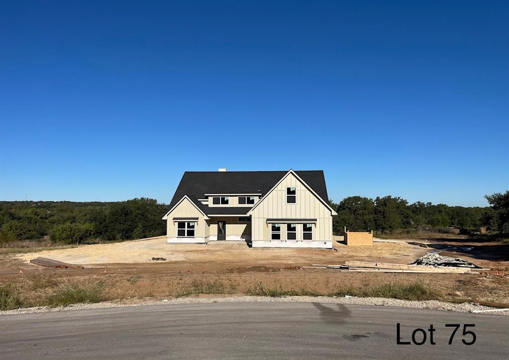 a view of house with yard and car parked