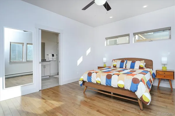 a bedroom with a bed and painting on the wall