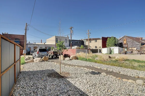 a view of a backyard with sitting area