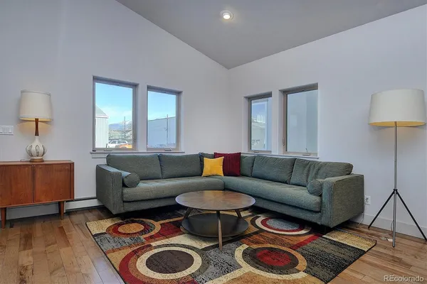 a living room with furniture and a lamp