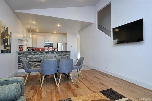 a view of a dining room with furniture and wooden floor