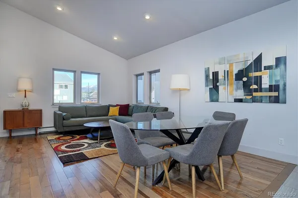 a living room with furniture and wooden floor