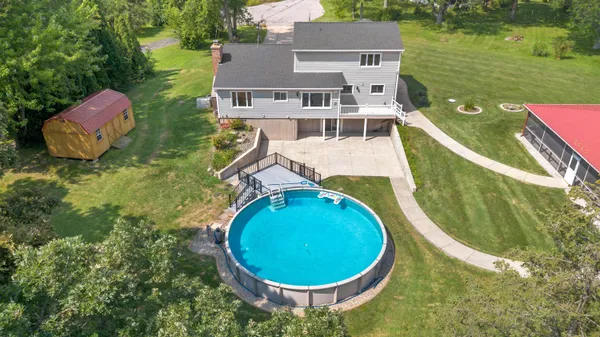 aerial view of a house with swimming pool and patio