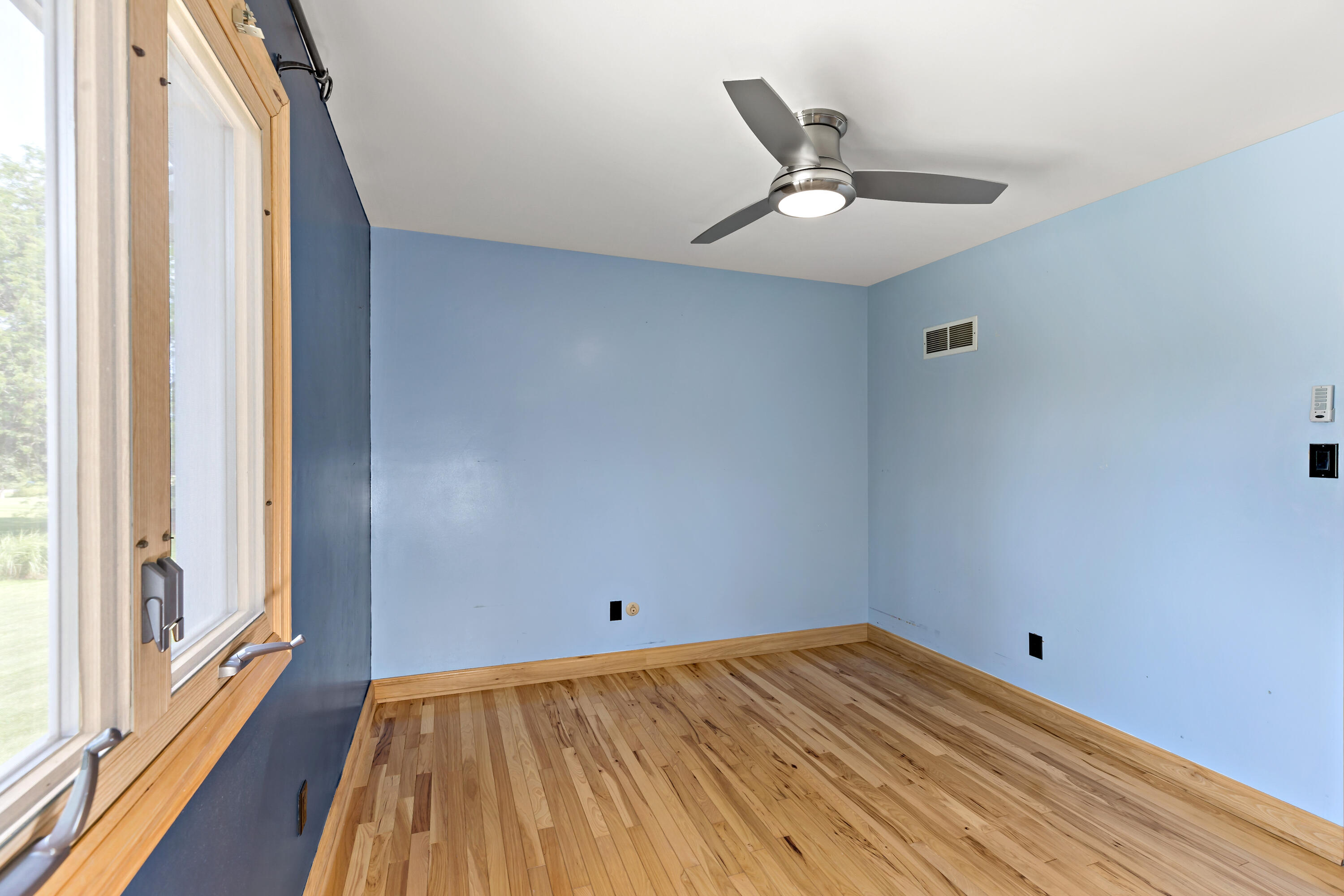5496 West 107th Court Crown Point, IN 46307 - Photo 23 of 48 a view of a room with wooden floor and ceiling fan