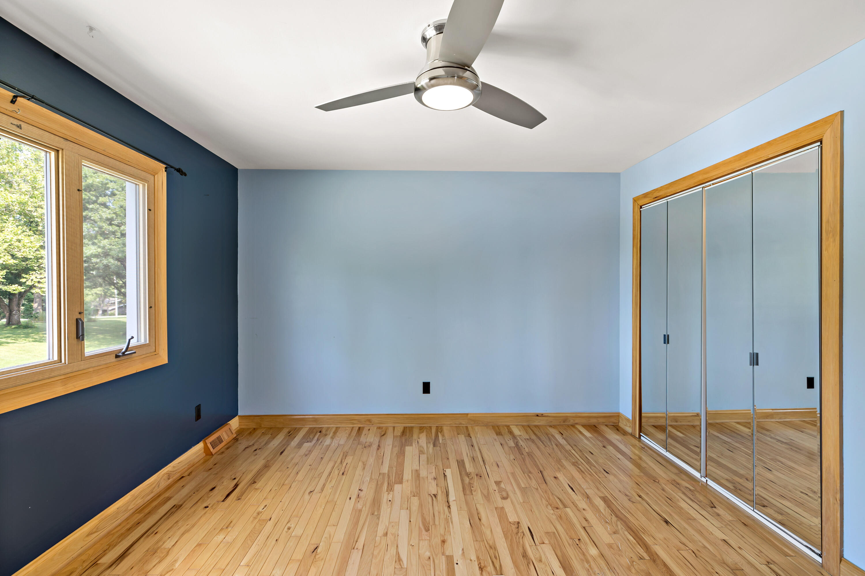 5496 West 107th Court Crown Point, IN 46307 - Photo 24 of 48 a view of empty room with wooden floor and fan