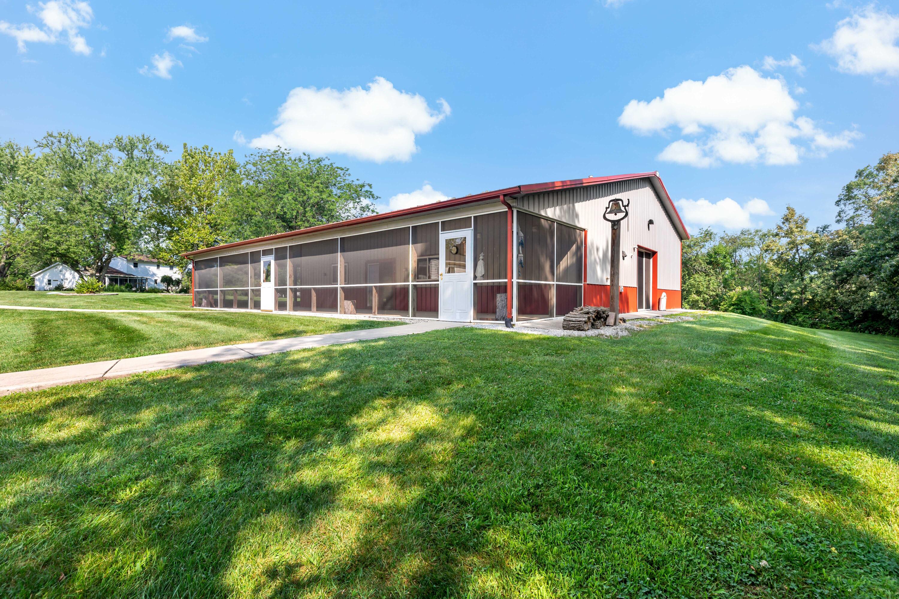 5496 West 107th Court Crown Point, IN 46307 - Photo 30 of 48 a view of a house with a big yard and large trees