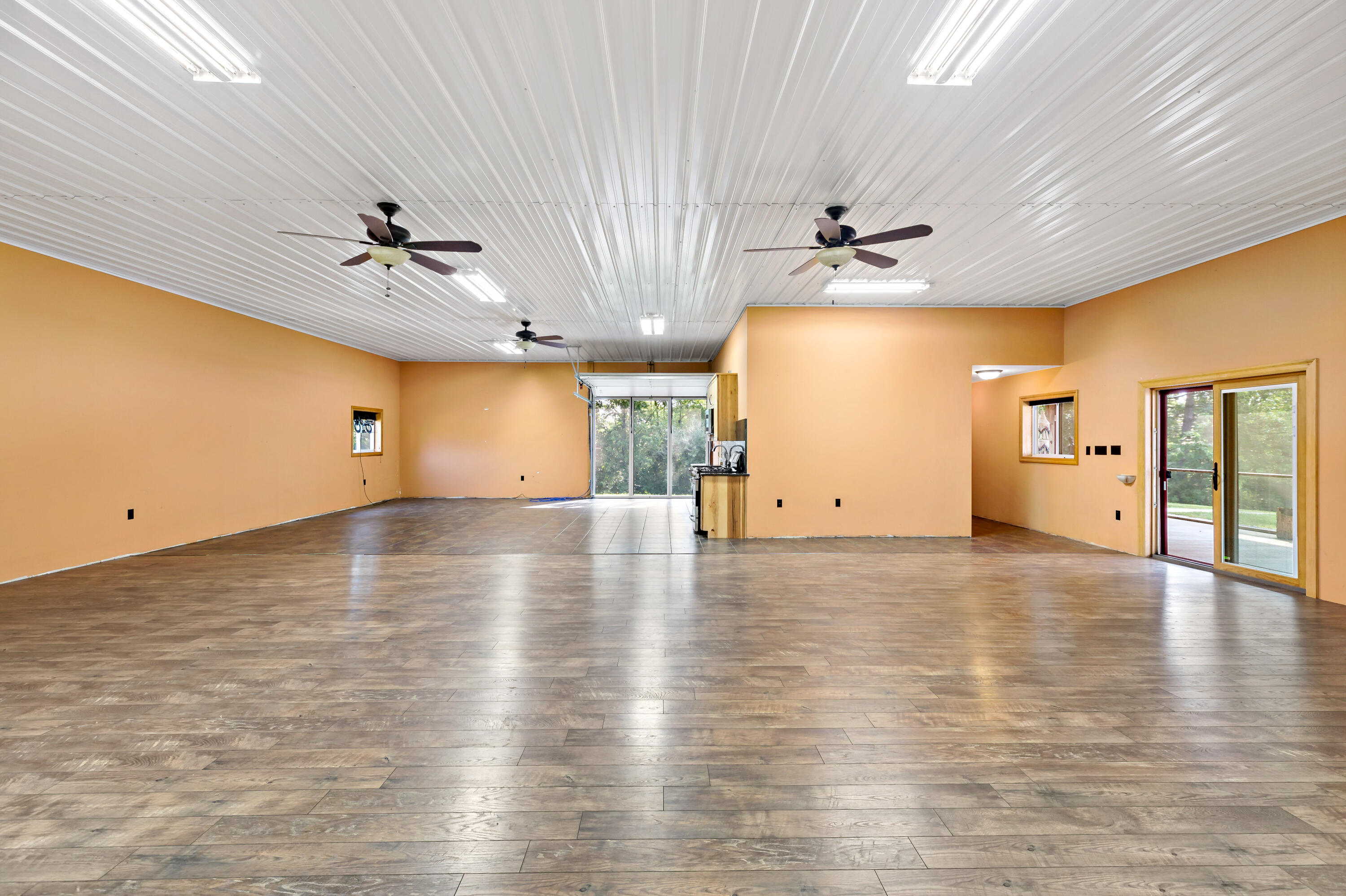 5496 West 107th Court Crown Point, IN 46307 - Photo 35 of 48 an empty room with wooden floor and a ceiling fan