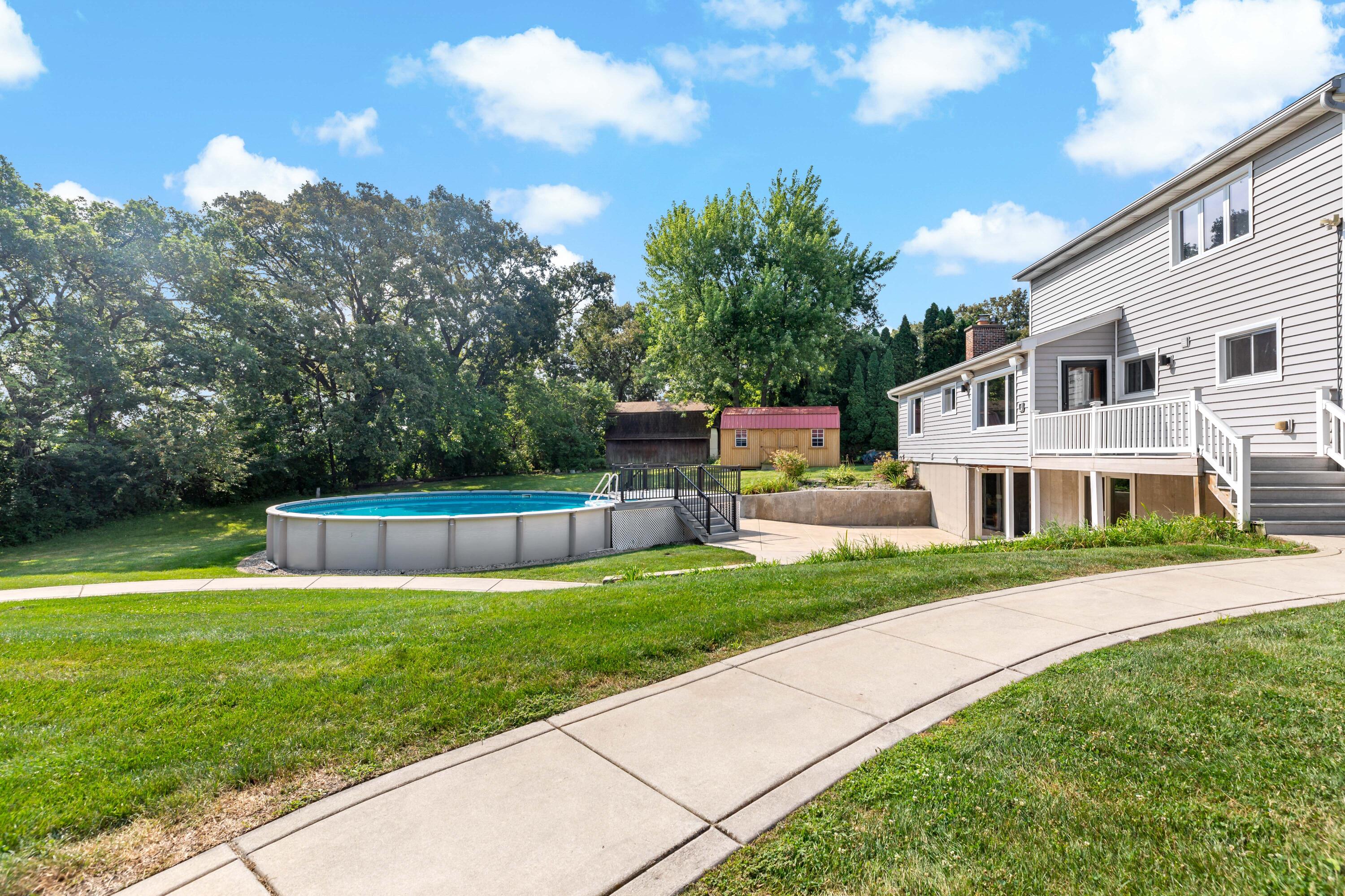 5496 West 107th Court Crown Point, IN 46307 - Photo 42 of 48 a view of a house with a big yard potted plants and a large tree