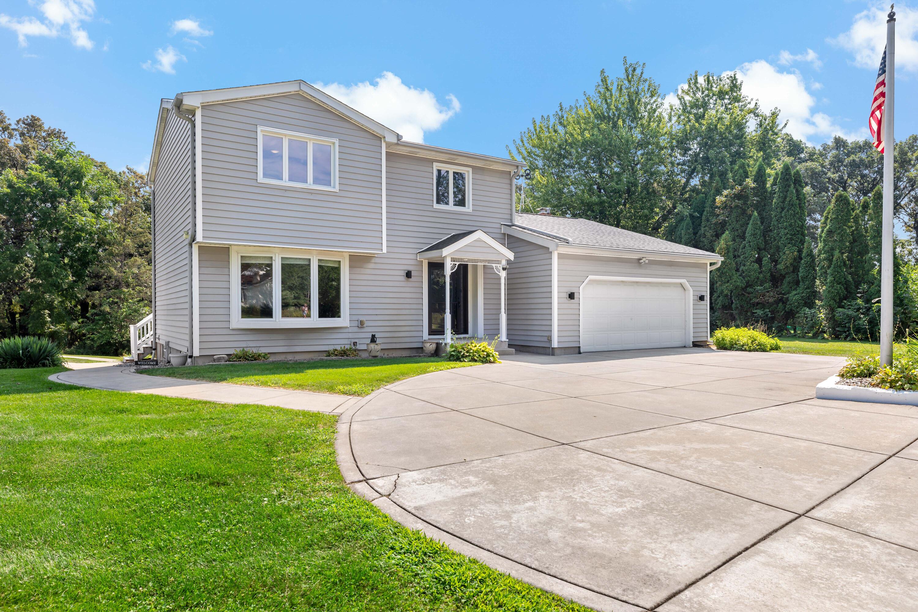 5496 West 107th Court Crown Point, IN 46307 - Photo 43 of 48 a front view of house with yard and trees in the background