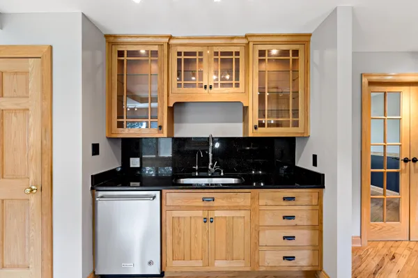 a kitchen with granite countertop a sink and cabinets