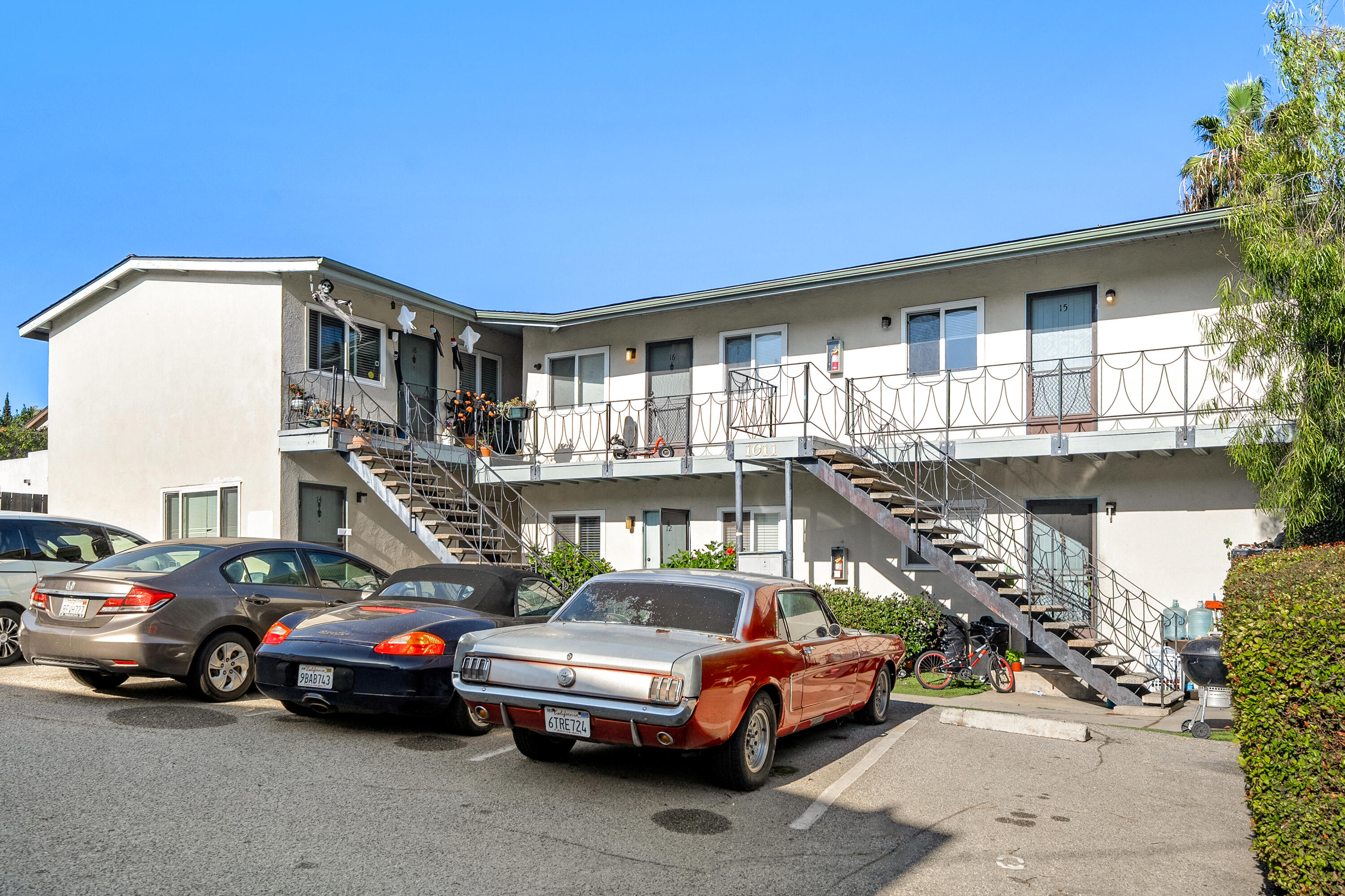 a front view of a house with cars parked