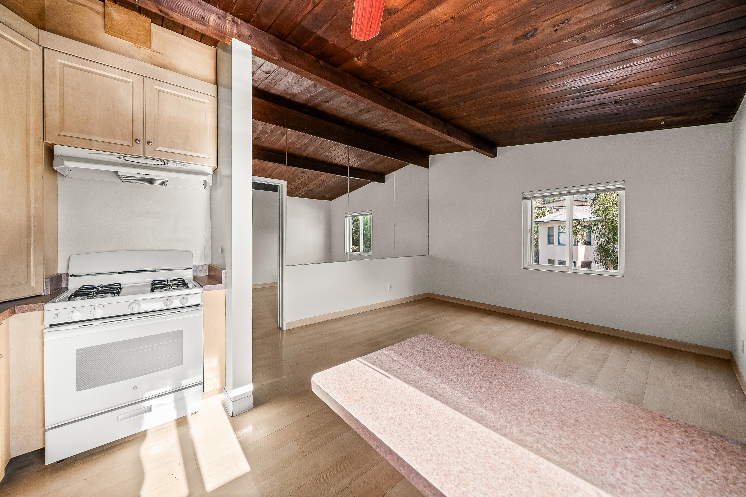 1011 Laguna Street Santa Barbara, CA 93101 - Photo 3 of 14 a view of a kitchen with wooden floor and electronic appliances