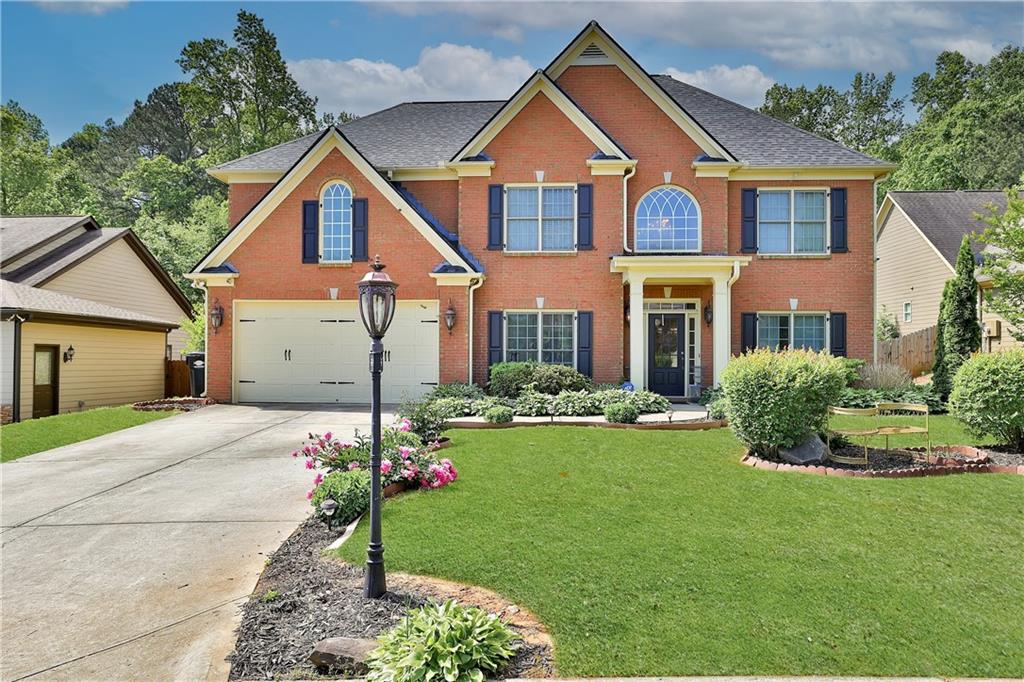 312 Dorys Way Dallas, GA 30157 - Photo 1 of 1 a front view of a house with a yard and garage