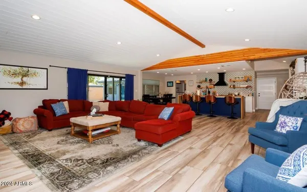 a living room with furniture a rug and a large window
